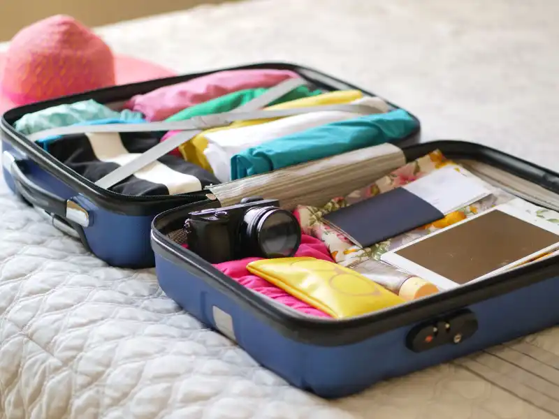 an open luggage with lightweight clothing